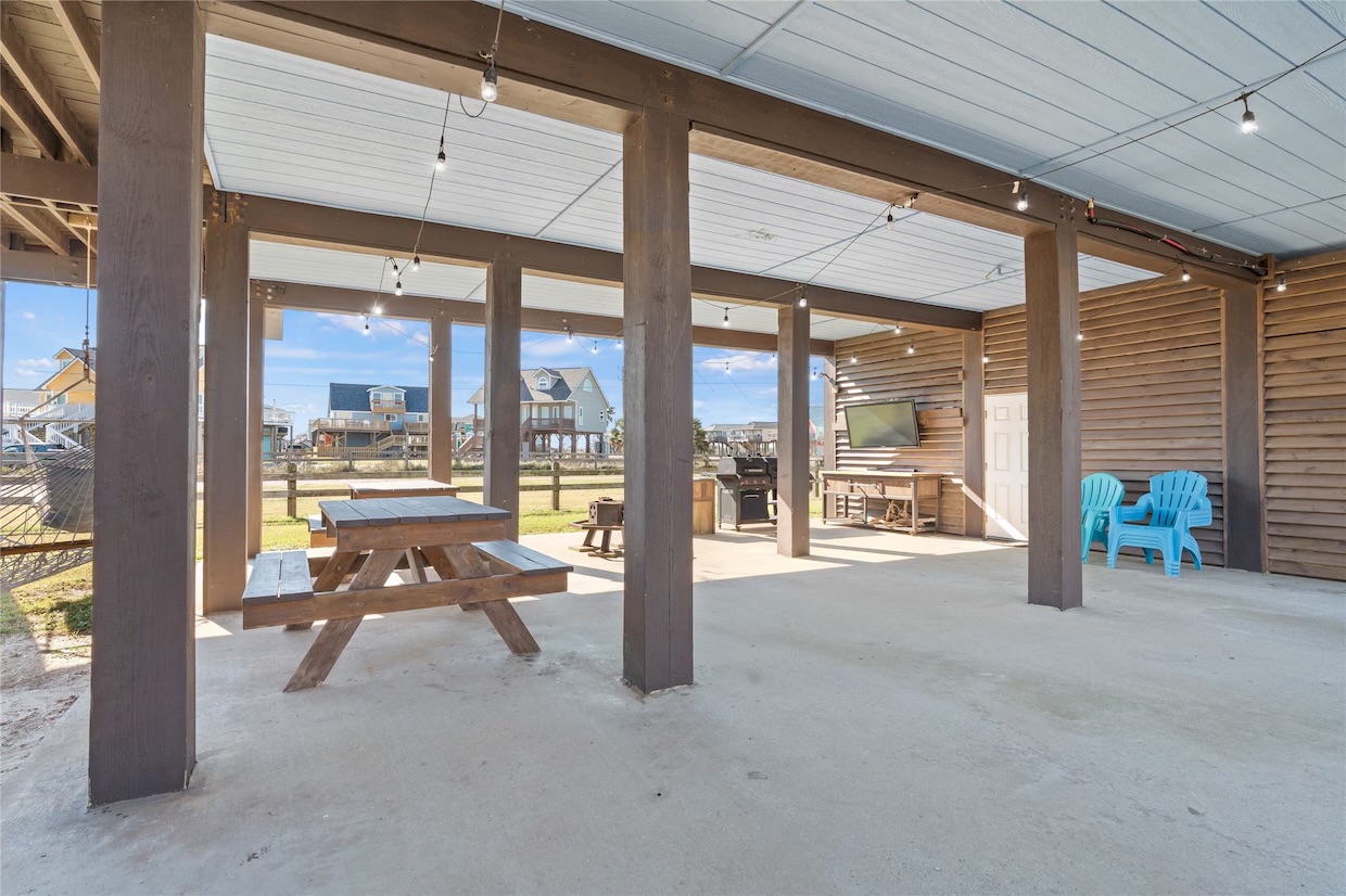 Outdoor grilling area with BBQ, sink, tables, outdoor shower, TV and more!